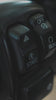 A close up shot of a rider clicking the start button of a motorcycle with their thumb