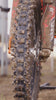 Close up shot of a motocross bike covered in mud after a race