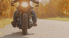 Motorcycle cruising down a road in slow motion 
