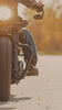 Motorcycle cruising down a road in slow motion 